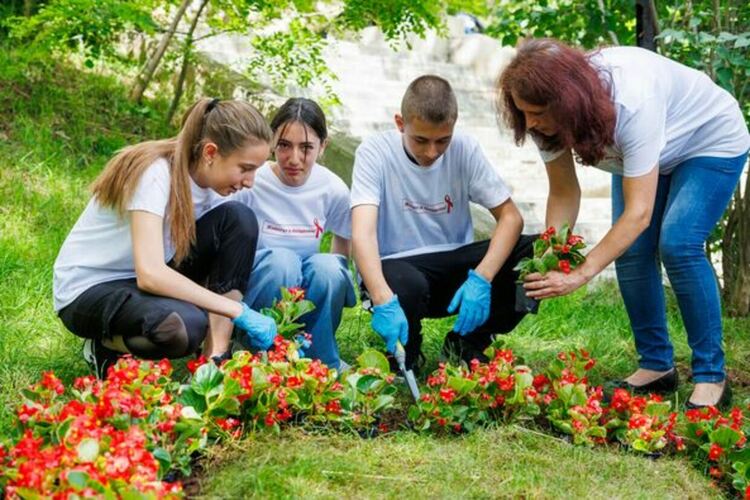Цветна леха под формата на червена панделка засадиха ученици от Радомир